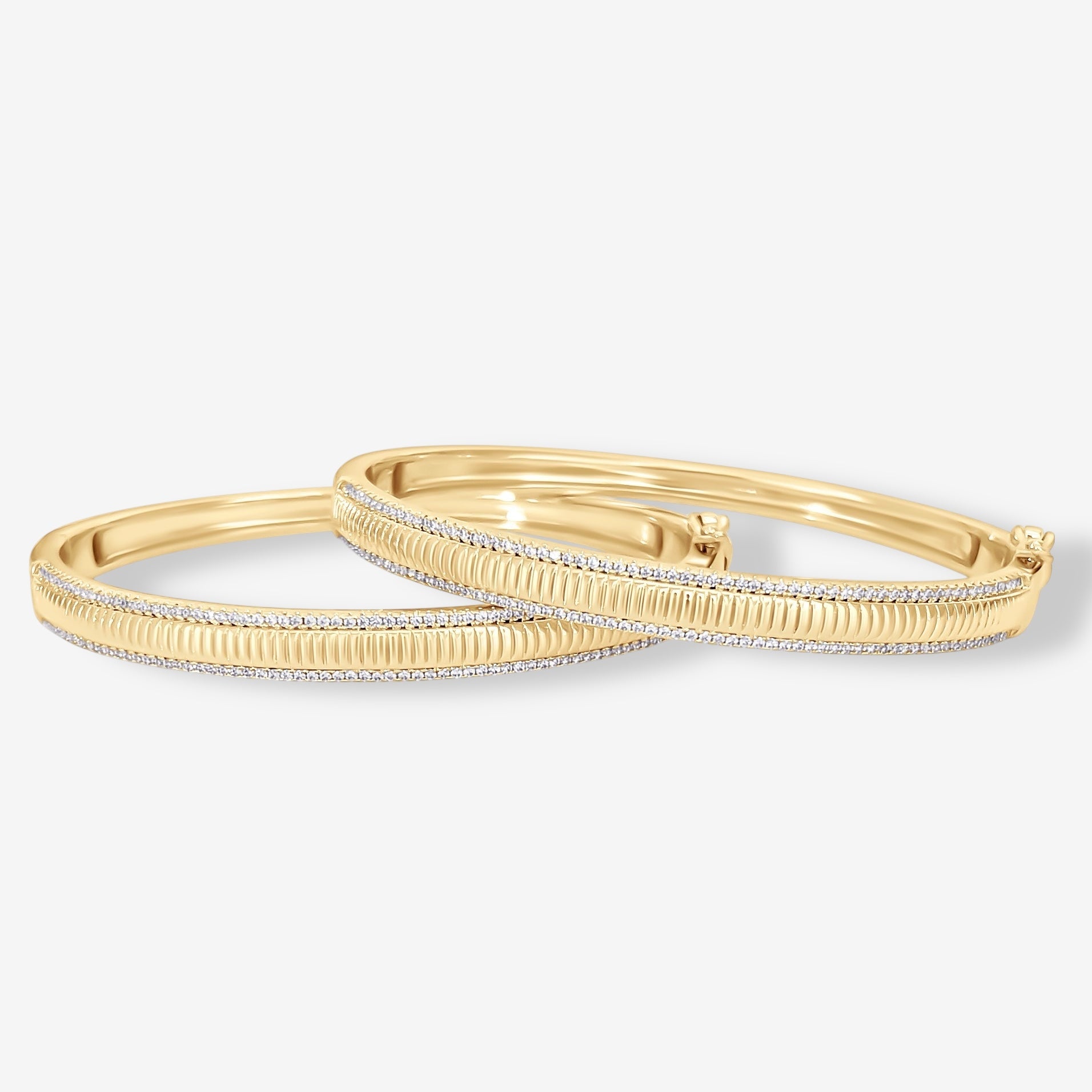 A pair of gold hoop earrings with textured centers, set against a plain white background, pairs beautifully with the Alyssa Fluted Bangle for a timeless look.