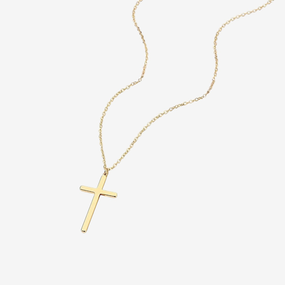 The Classic Cross Necklace features a simple gold chain with an elegant gold cross pendant, shown on a white background—perfect for timeless style on any occasion.