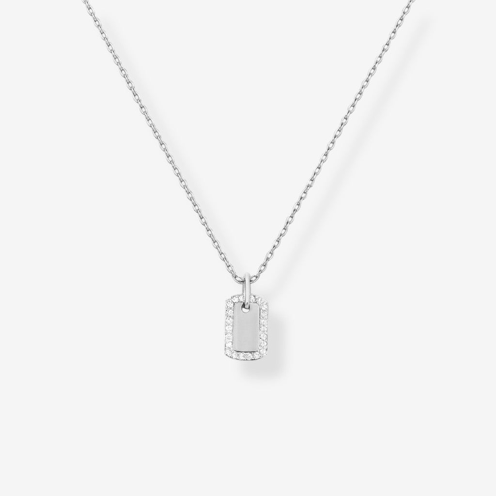 The Dainty Dog Tag Necklace – Silver showcases a small rectangular sterling silver pendant outlined with pavé simulated diamonds, suspended from a fine chain on a plain white background.