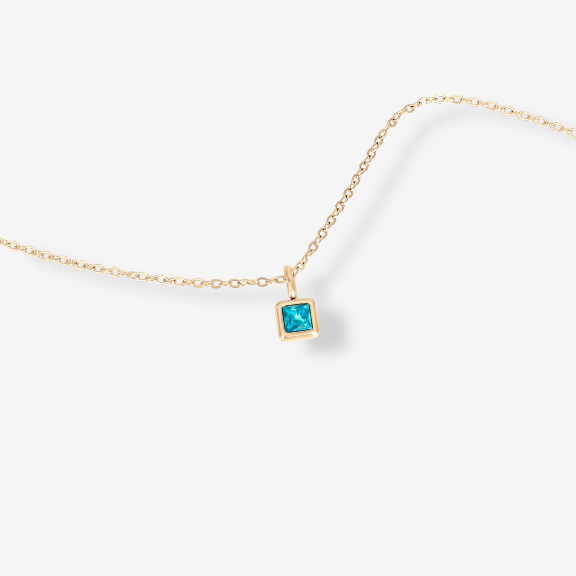 Gold Abel Birthstone Necklace featuring a single square-cut teal birthstone charm shown on a clean white background