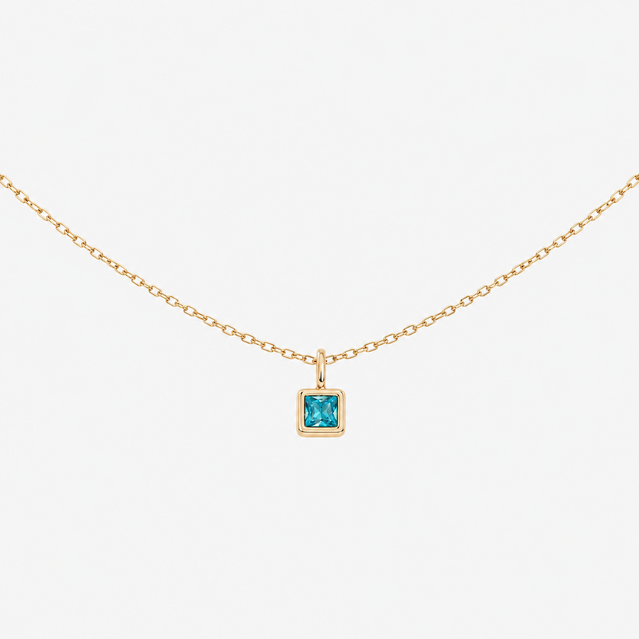 Abel Gold 18k stainless steel birthstone necklace with a square blue gemstone pendant on a white background
