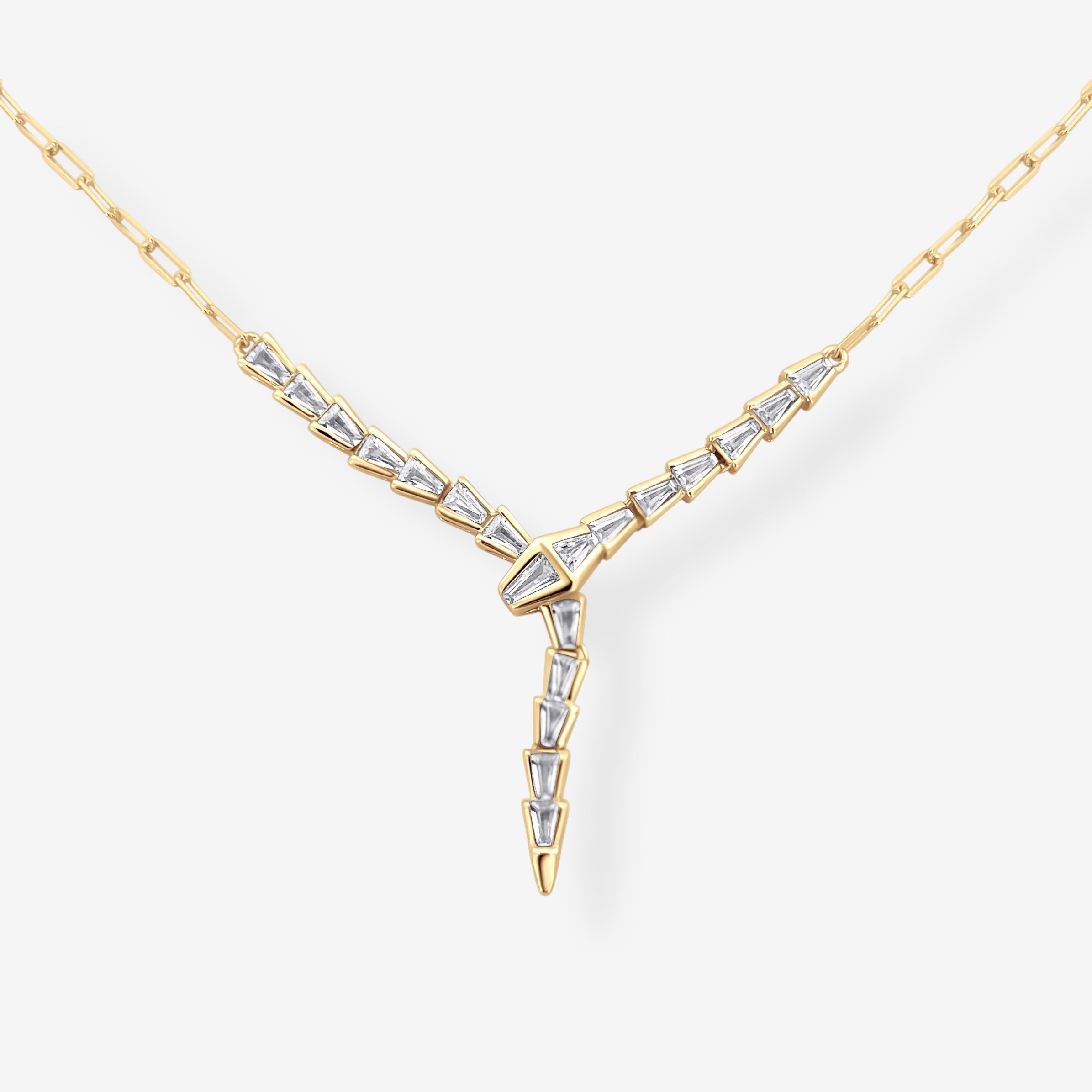 Baguette Snake Necklace in gold shown in flat lay featuring a 14k gold plated Y drop snake design crafted in 925 sterling silver accented with baguette cut stones on a neutral background