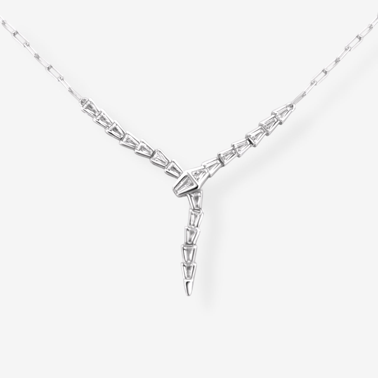 Baguette Snake Necklace in silver shown in flat lay featuring a 925 sterling silver Y drop snake design accented with baguette cut stones on a neutral background