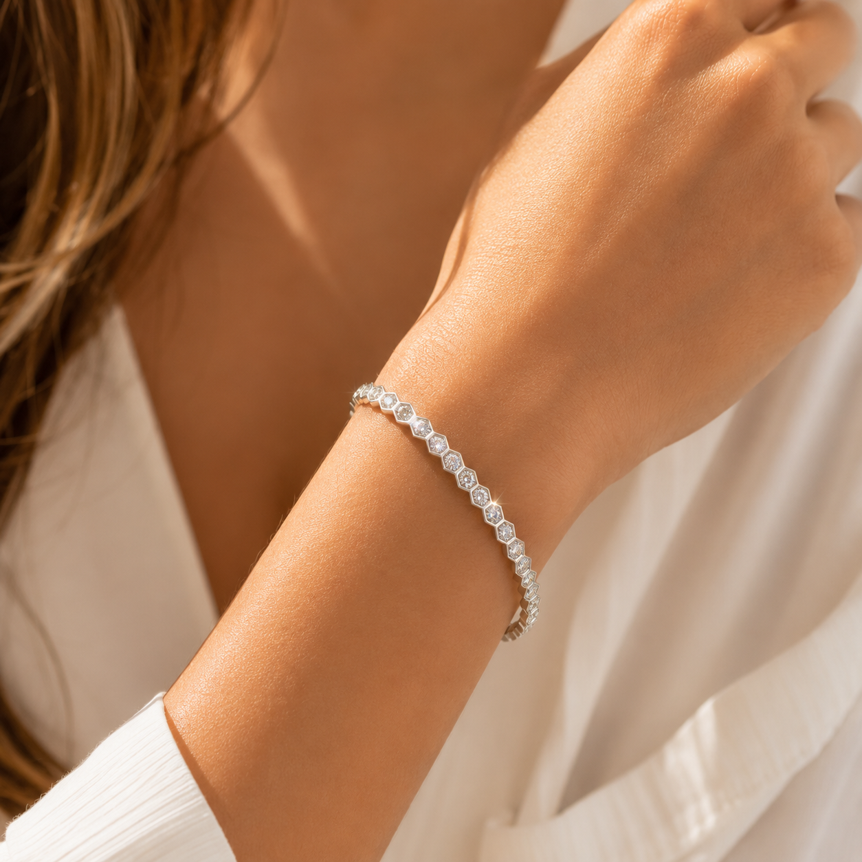 Model wearing silver hexagon tennis bracelet with minimalist everyday jewelry styling