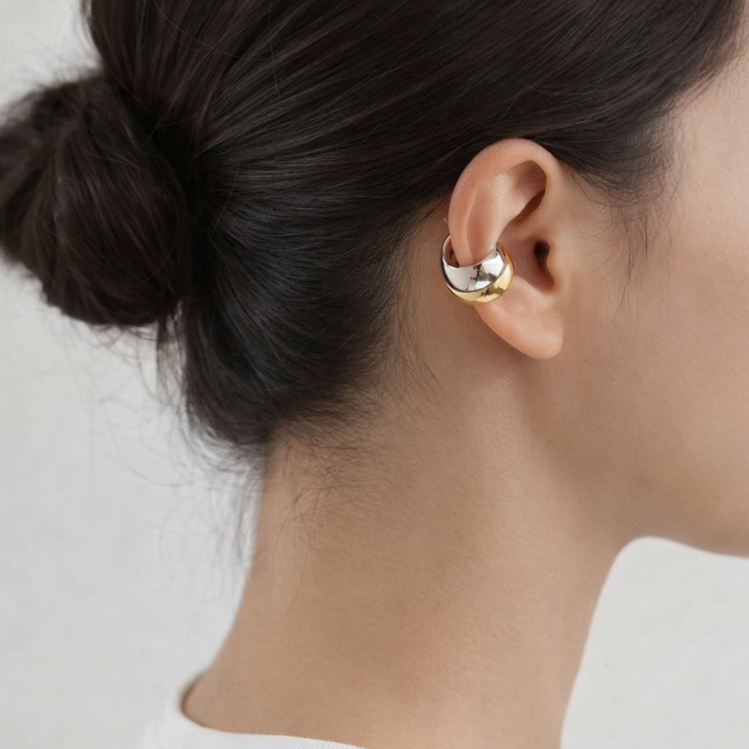 Luna two tone ear cuff worn on model showing mixed gold and silver tones with a modern minimalist look