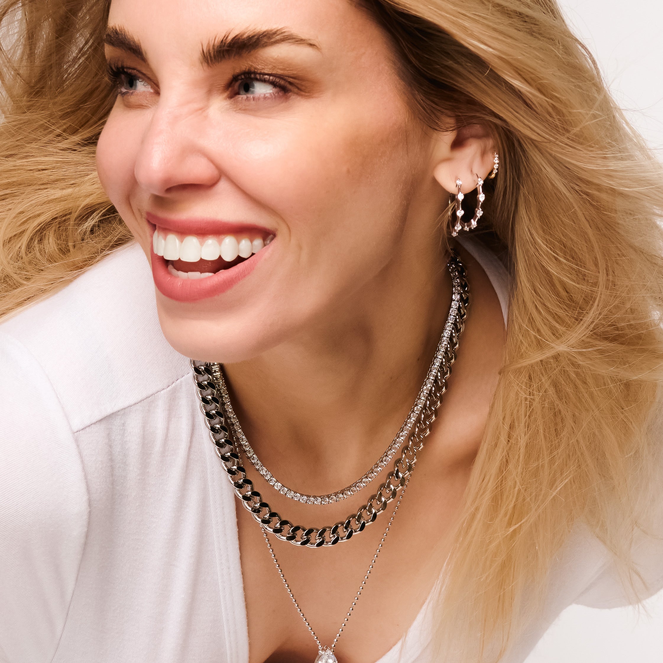Woman wearing Meliss Sparkle Hoop Earrings Silver and Silver Necklaces - Luxxy Jewelry | Affordable Luxury Jewelry