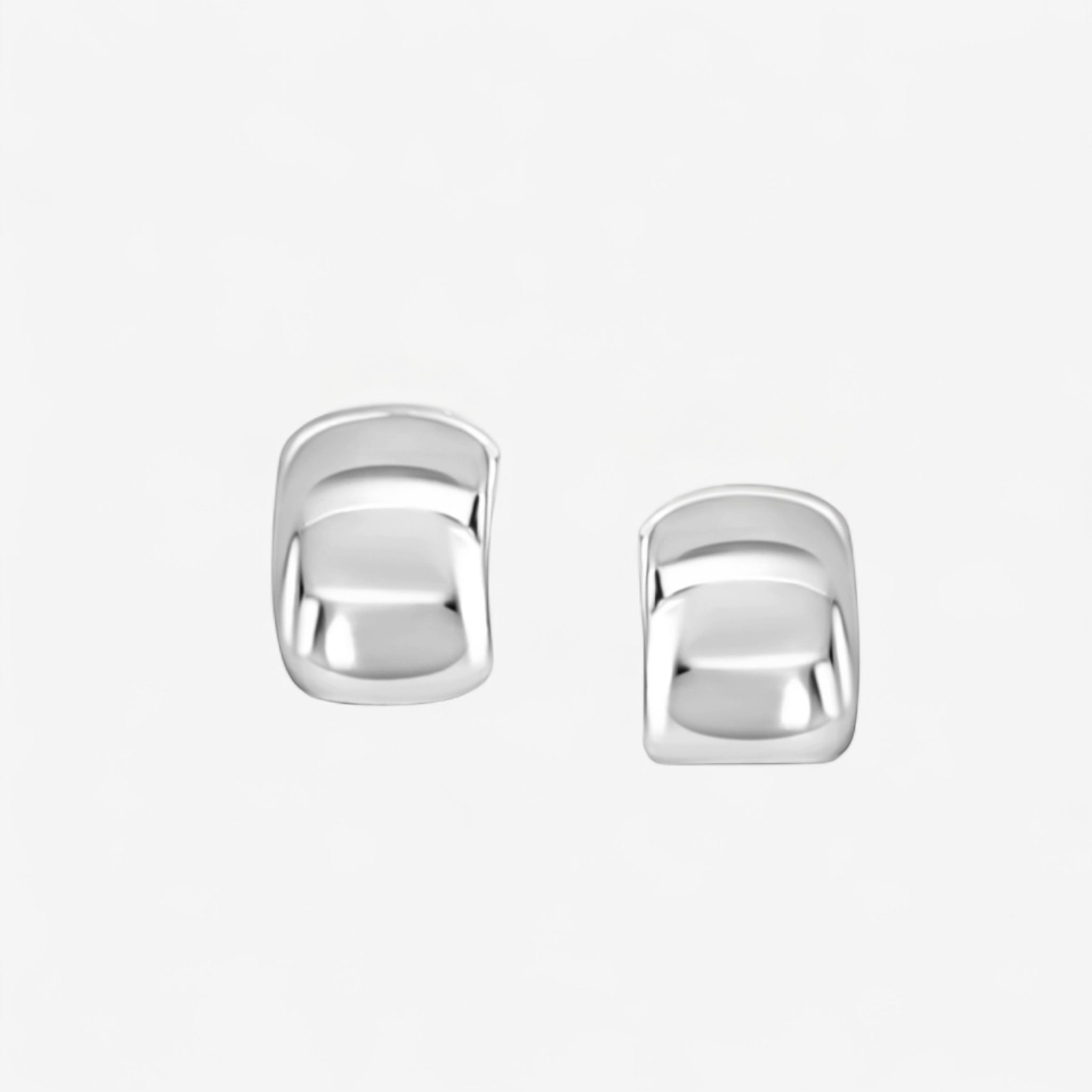 A pair of Brookes Curved Stud Earrings, featuring a shiny, polished silver finish with square shapes and slightly rounded edges, displayed on a plain white background.