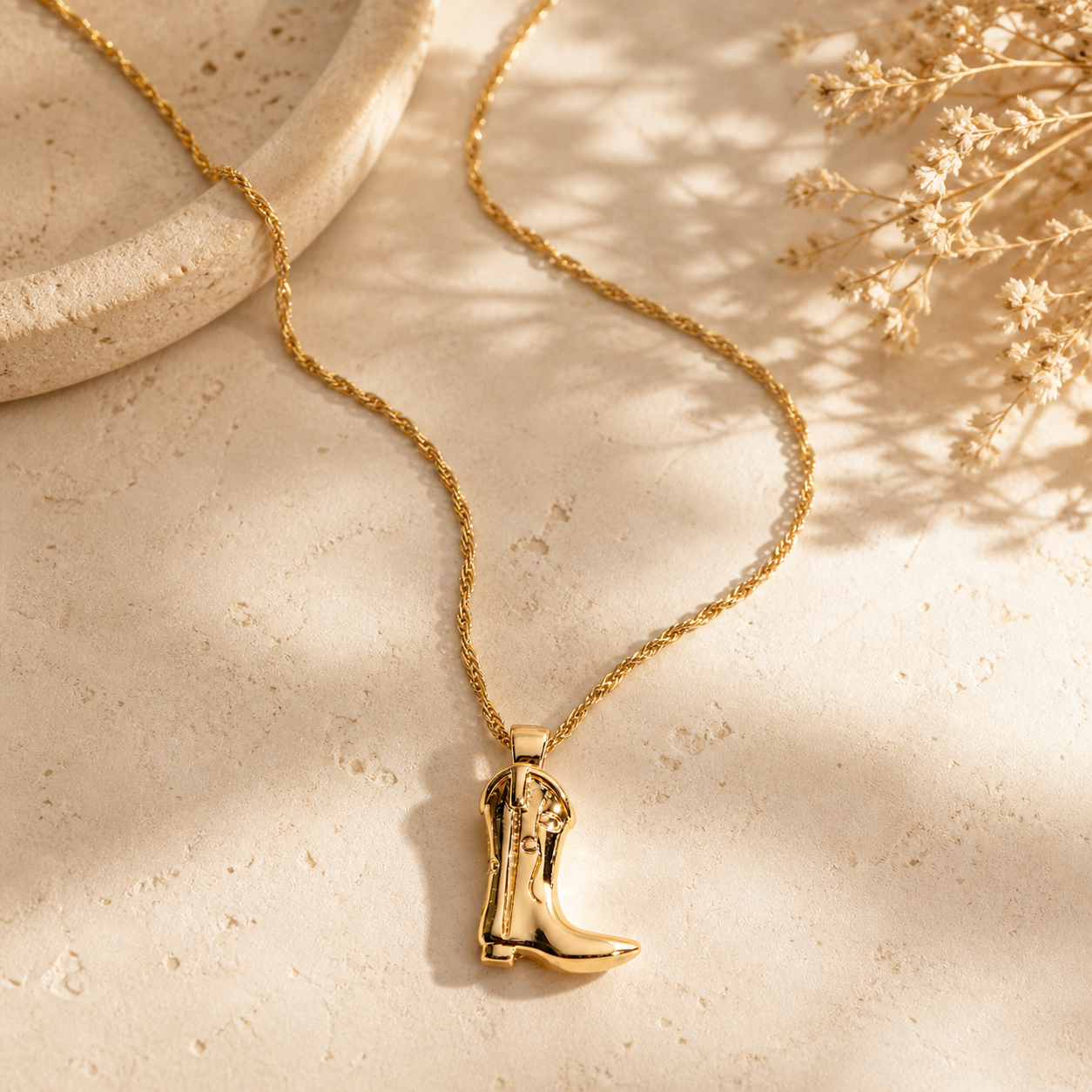 18k Stainless Steel Gold cowgirl boot pendant necklace with polished twist chain styled on neutral background
