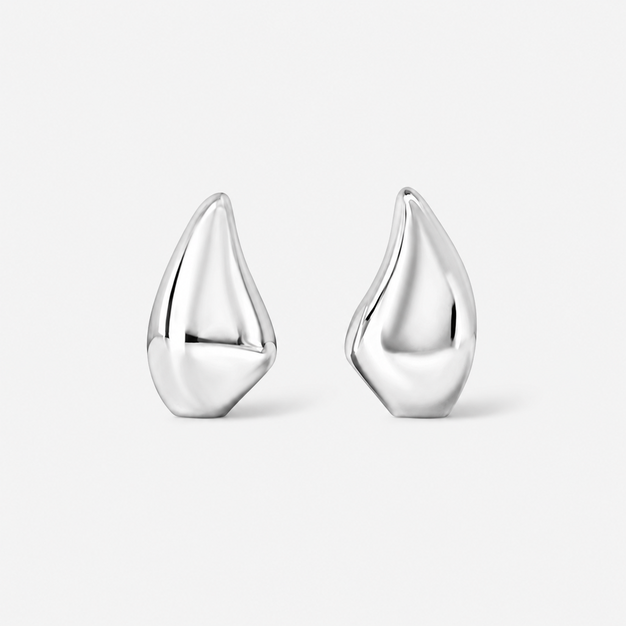 Close up of Demi silver teardrop earrings in high polished silver against light gray background 
