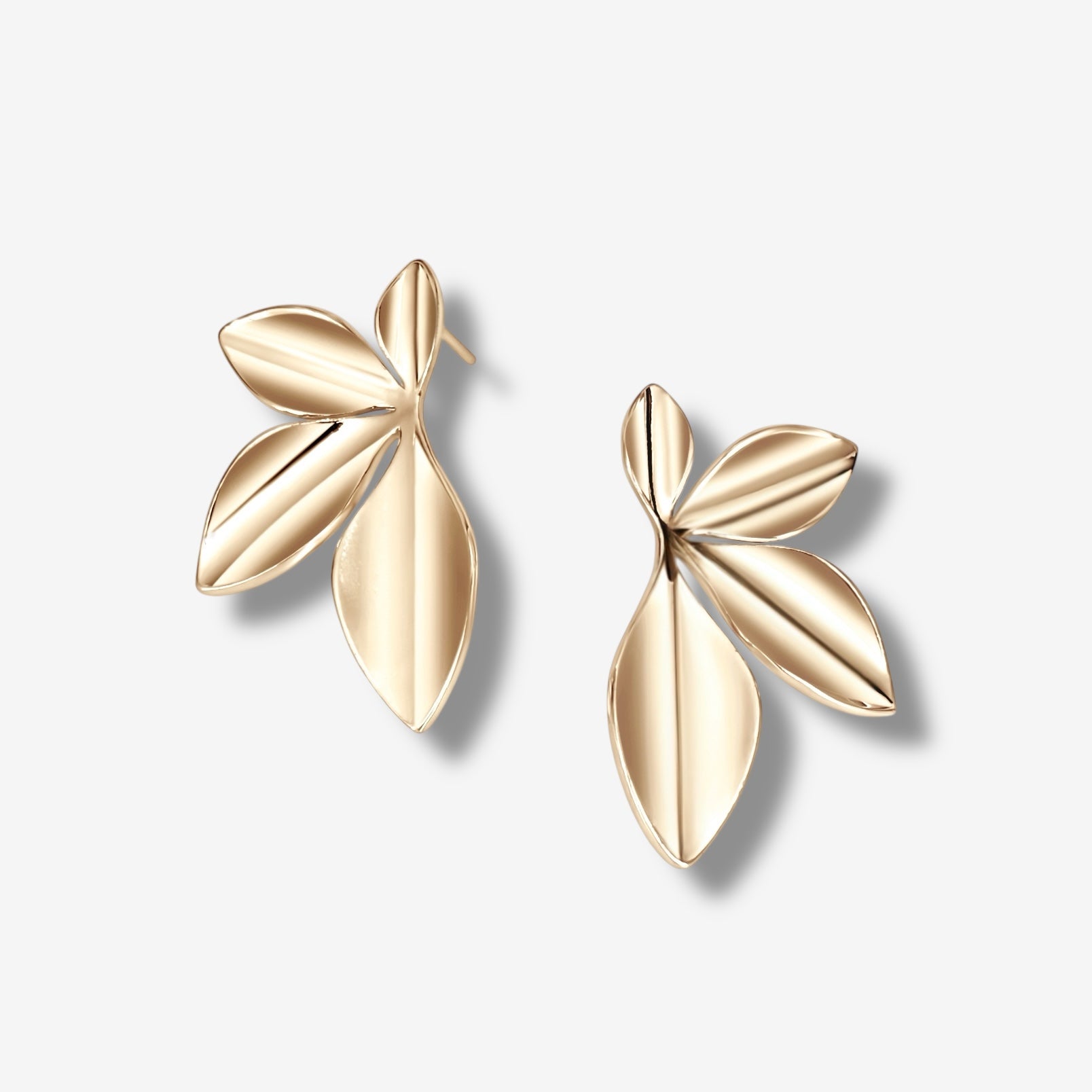 The Harper Statement Petal Earring features a 14k gold plated, abstract petal design with three smooth, overlapping segments per earring. Displayed on a plain light background, these modern earrings add an elegant touch