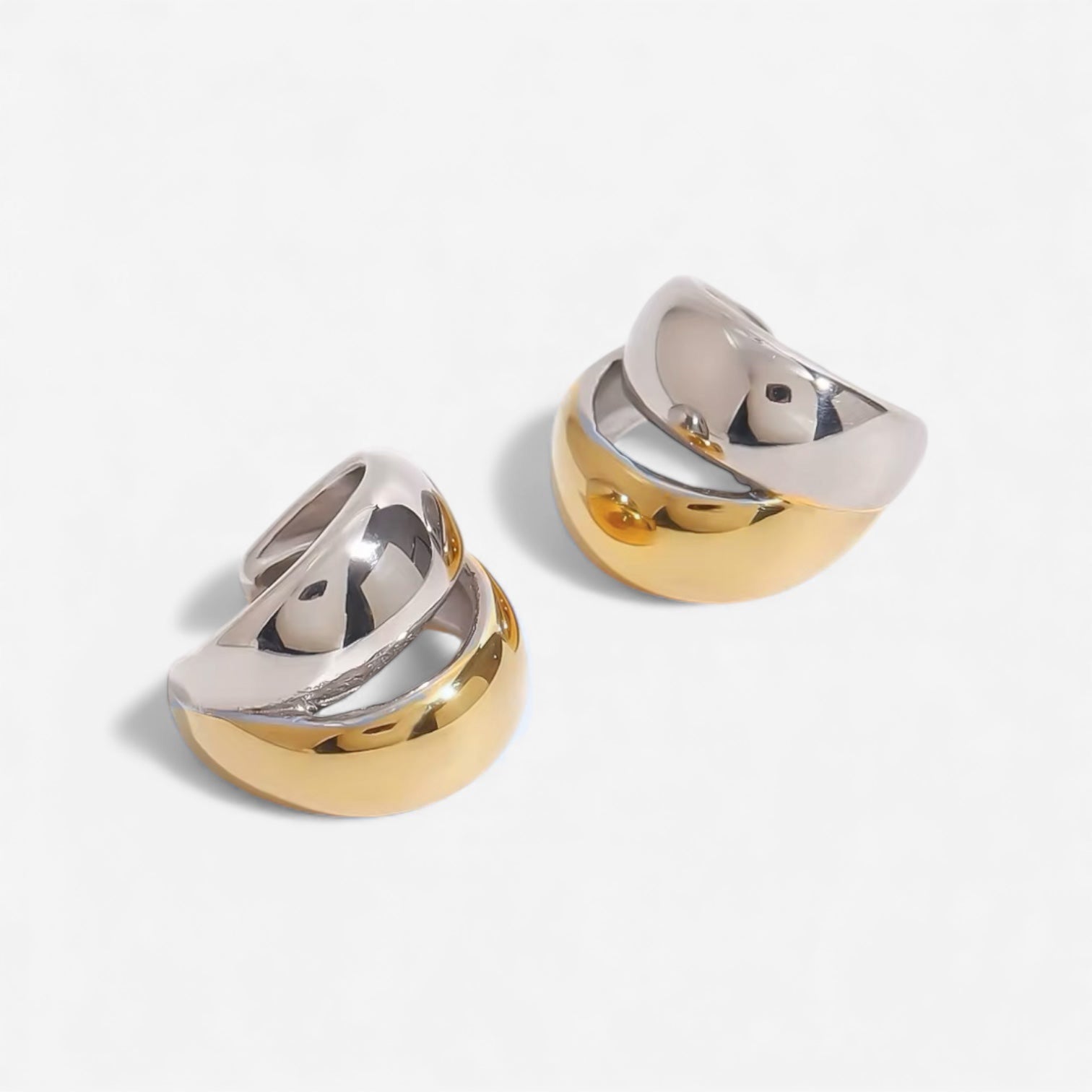Luna two tone ear cuff featuring polished gold and silver finish in a sculptural curved design
