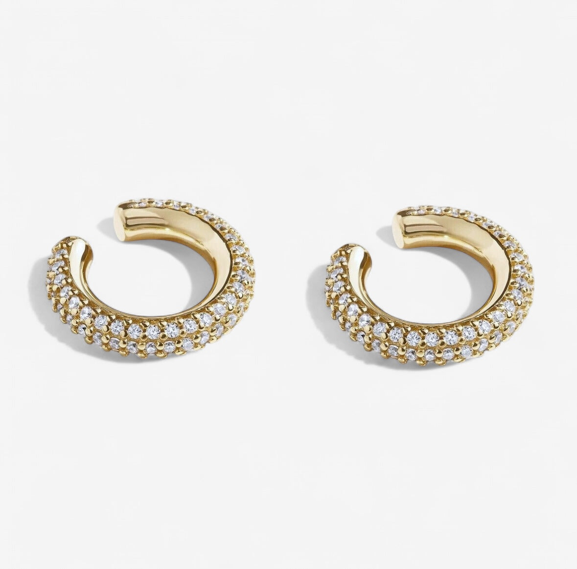 The Kalie Billionaire Ear Cuff Set features 14k gold plated earrings with three rows of sparkling clear stones, displayed against a plain white background.