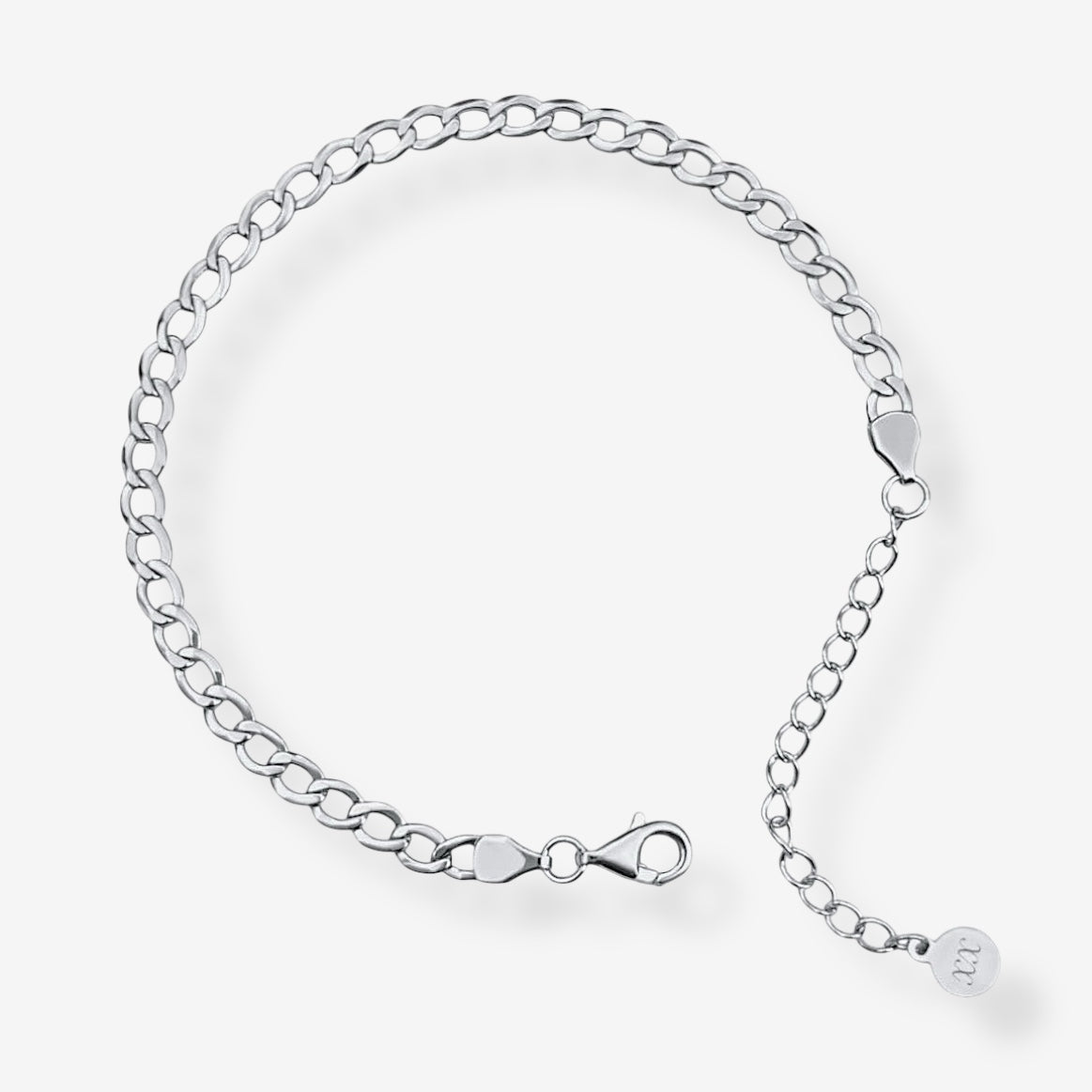 The Brynn Cuban Bracelet is a delicate sterling silver piece with oval links, a lobster clasp, and an extension chain ending in a small round charm. Rhodium plating adds shine and durability to this elegant bracelet.