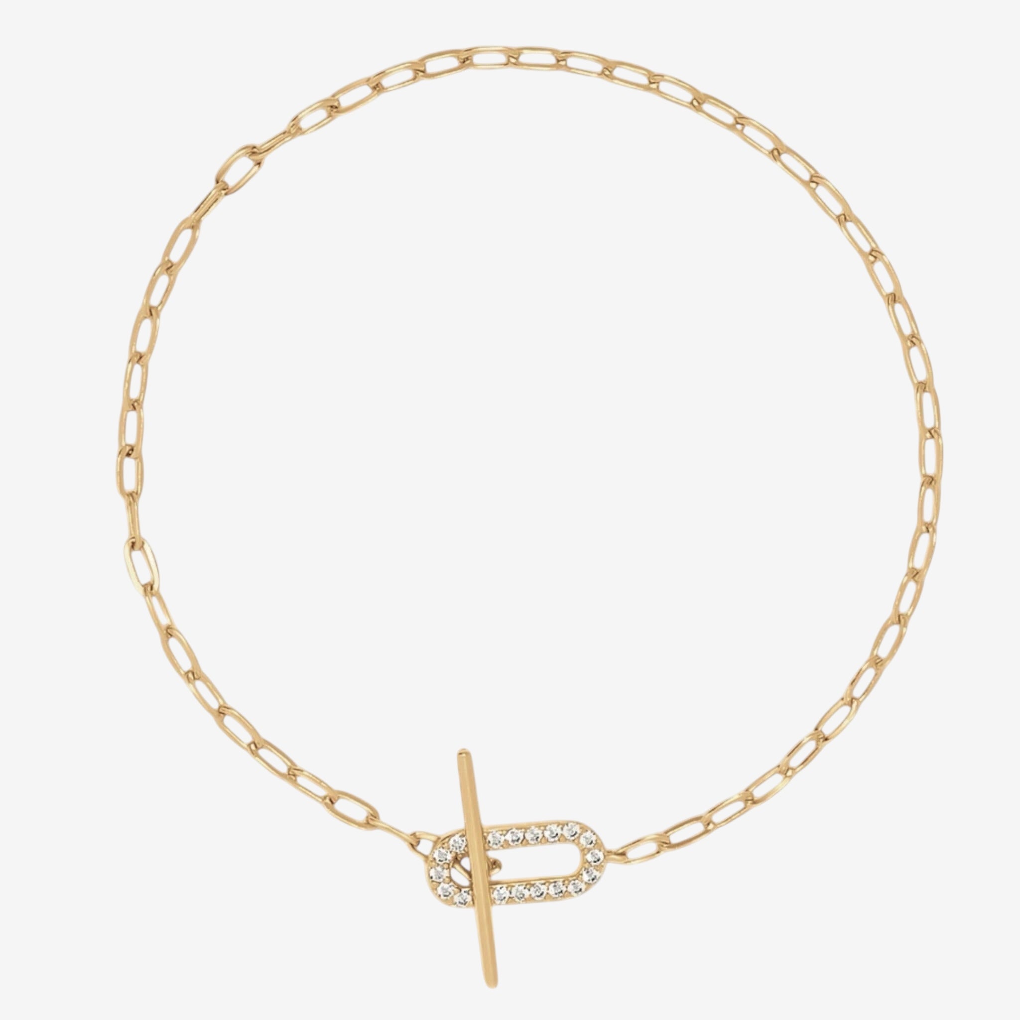 The Jules Bracelet is a delicate gold chain with elongated links, highlighted by an oval-shaped simulated diamond clasp as its sparkling centerpiece.