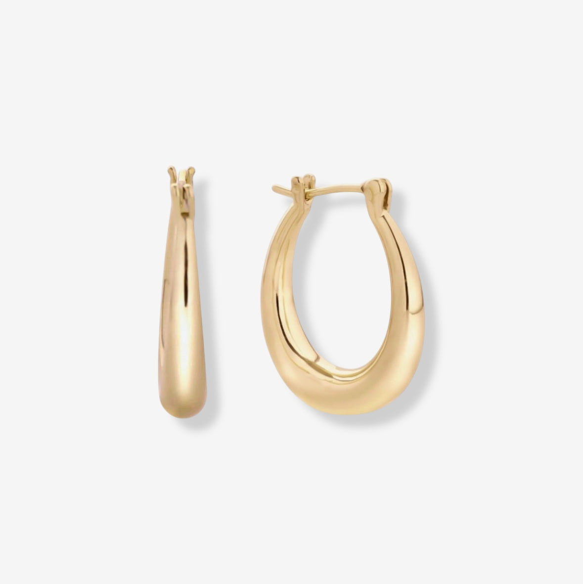 Riley Oval Hoops are 14k gold plated earrings with a subtle oval shape. Shown from the front and side against a white background, these everyday gold hoops are perfect for any occasion.