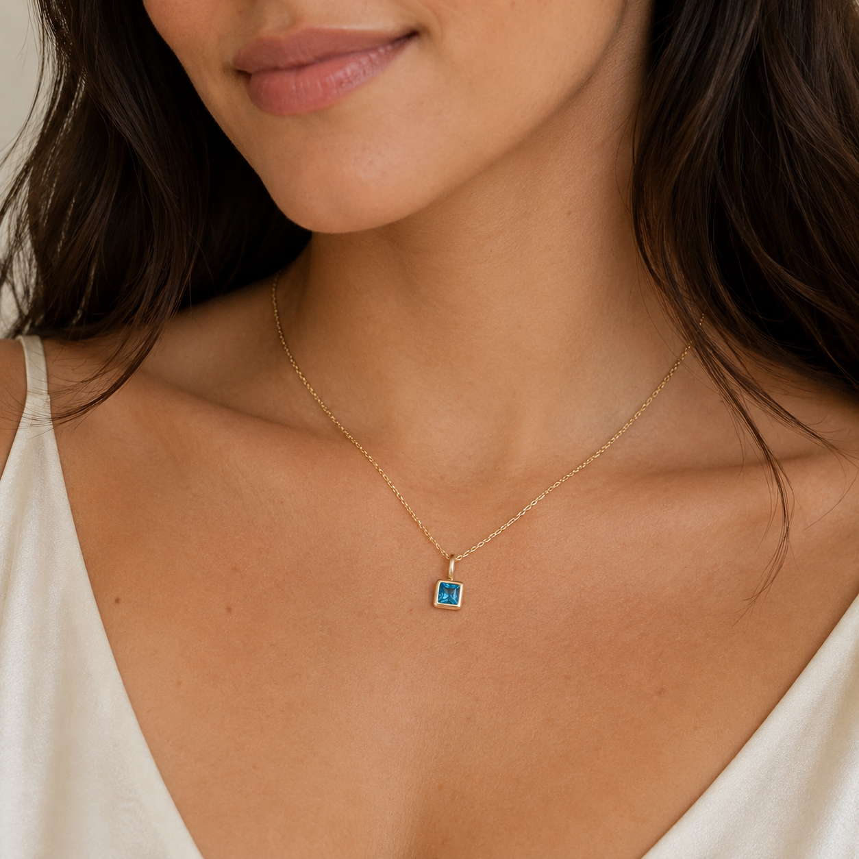Model wearing dainty gold single birthstone necklace with minimalist everyday jewelry styling